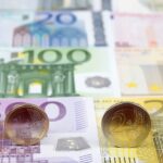 Euro coins on the background of banknotes