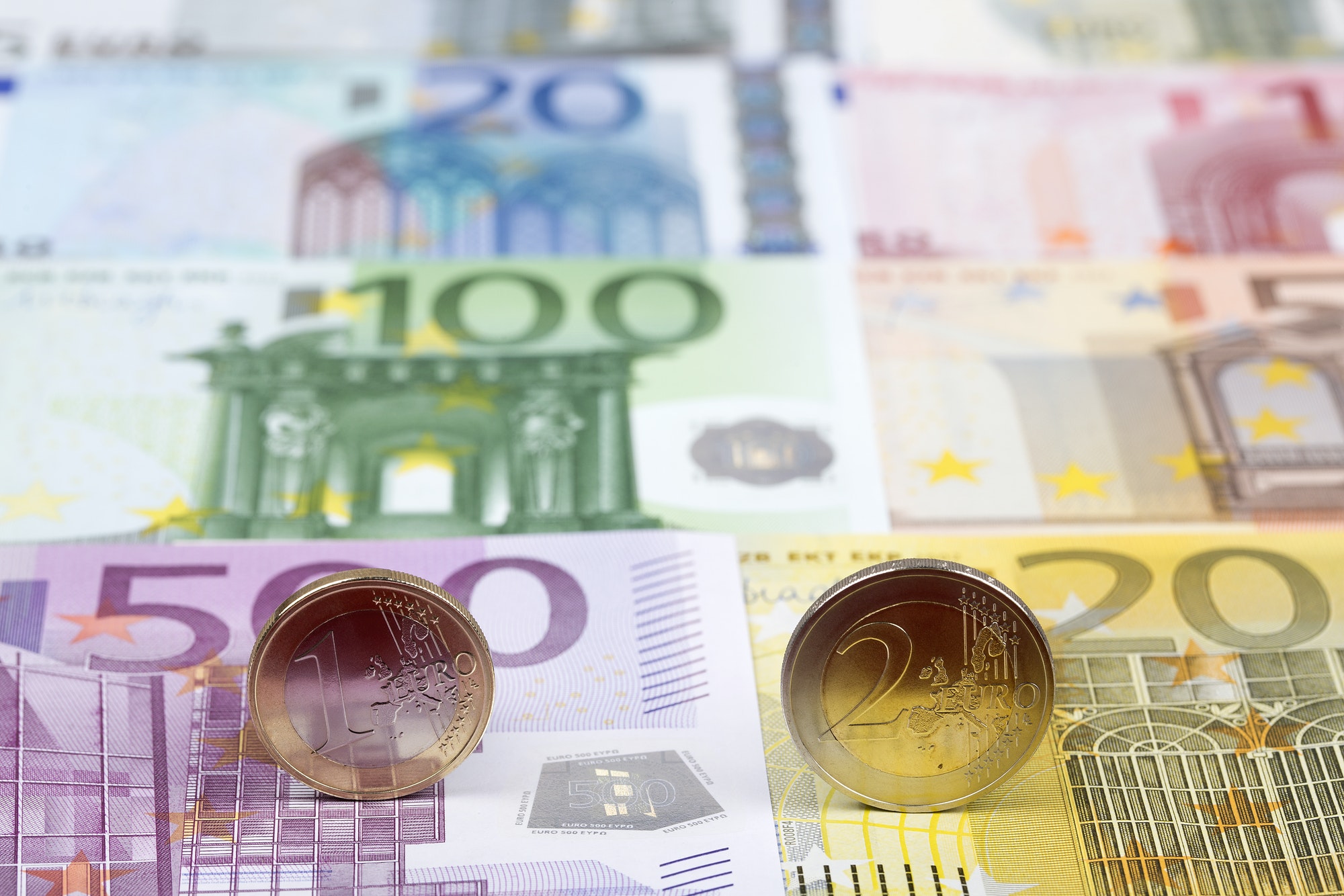 Euro coins on the background of banknotes